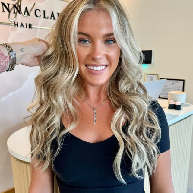 Bright blonde balayage with a lived-in root and loose curls