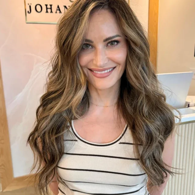 Long brunette balayage with soft bronde ribbons and loose waves